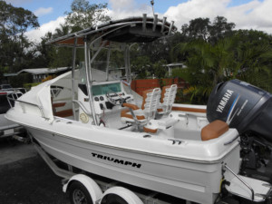 White Triumph boat with Yamaha outboard.
