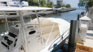 A boat is docked at the dock in front of some buildings.