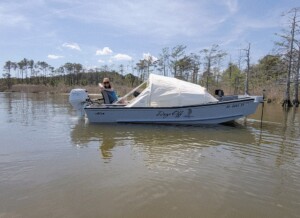 Boat with canopy on calm lake water.