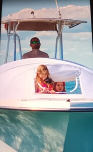Man and children on a boat ride.