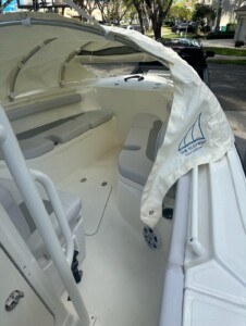 Open-top boat with cushioned seating area.