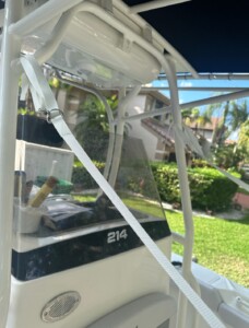 Boat console with steering wheel and controls.